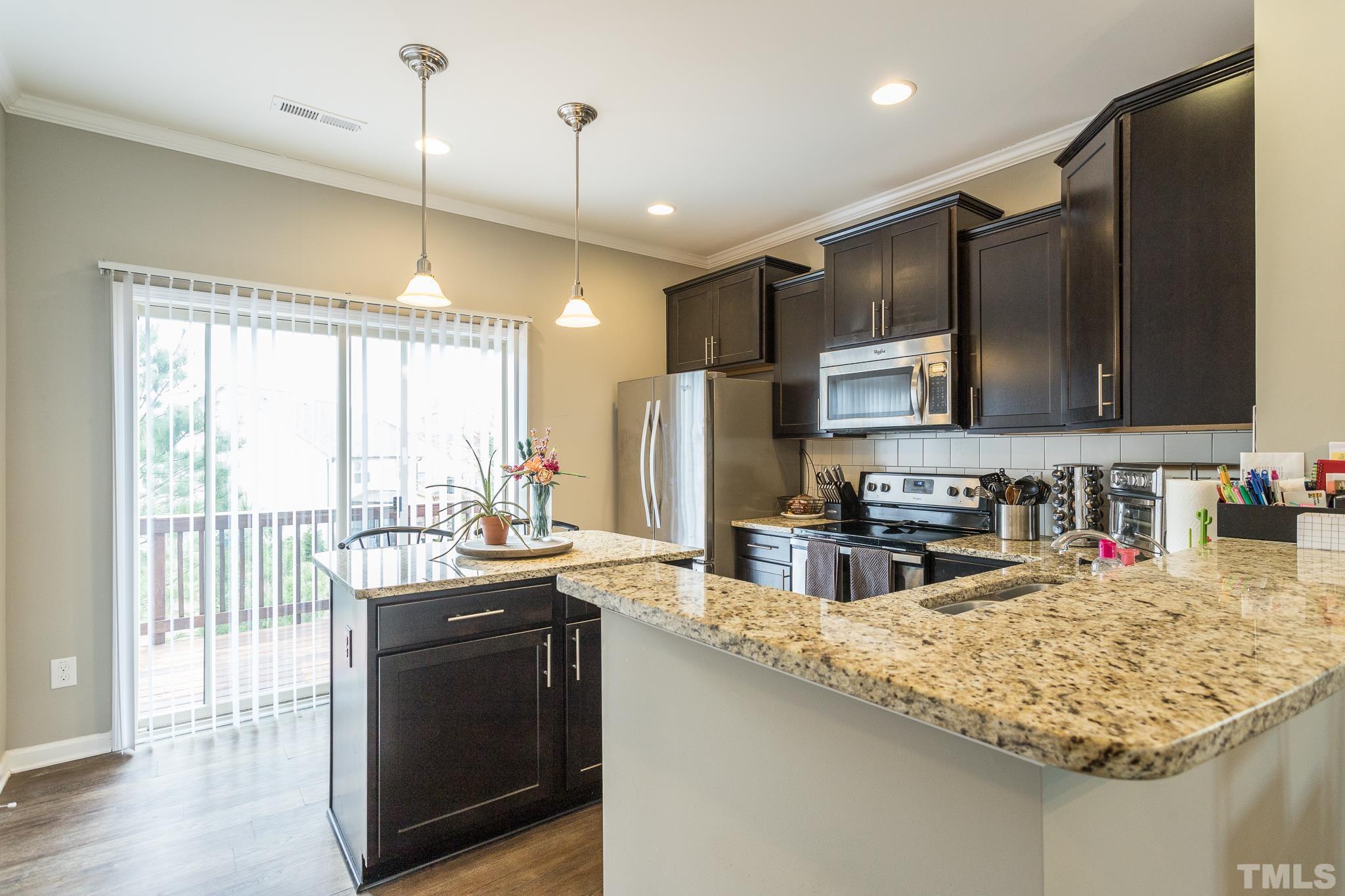 218 Irving Way Durham, NC 27703 - Photo 15 of 41 a kitchen with stainless steel appliances granite countertop a sink stove and refrigerator