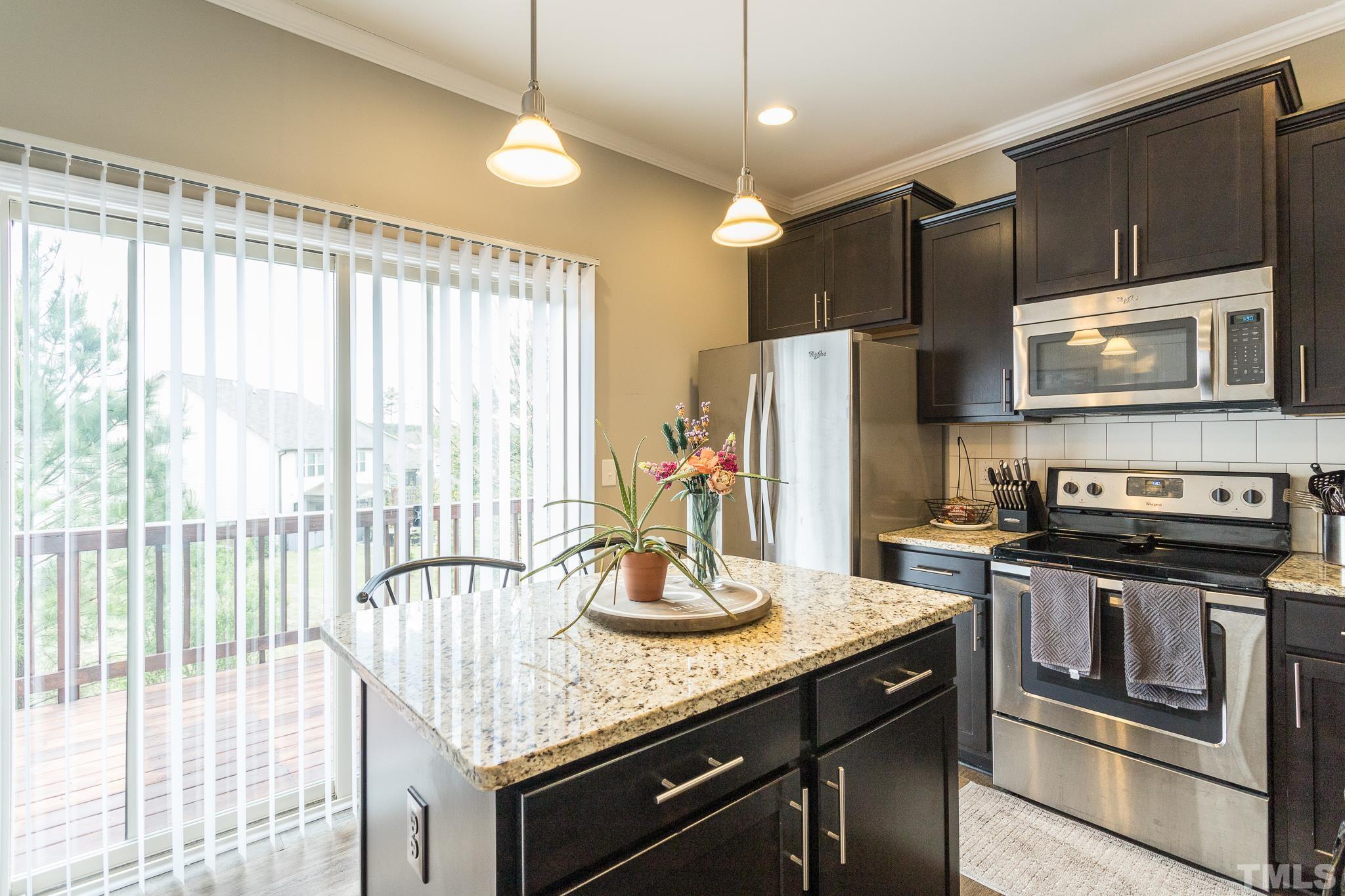 218 Irving Way Durham, NC 27703 - Photo 16 of 41 a kitchen with stainless steel appliances granite countertop a stove a refrigerator and a microwave