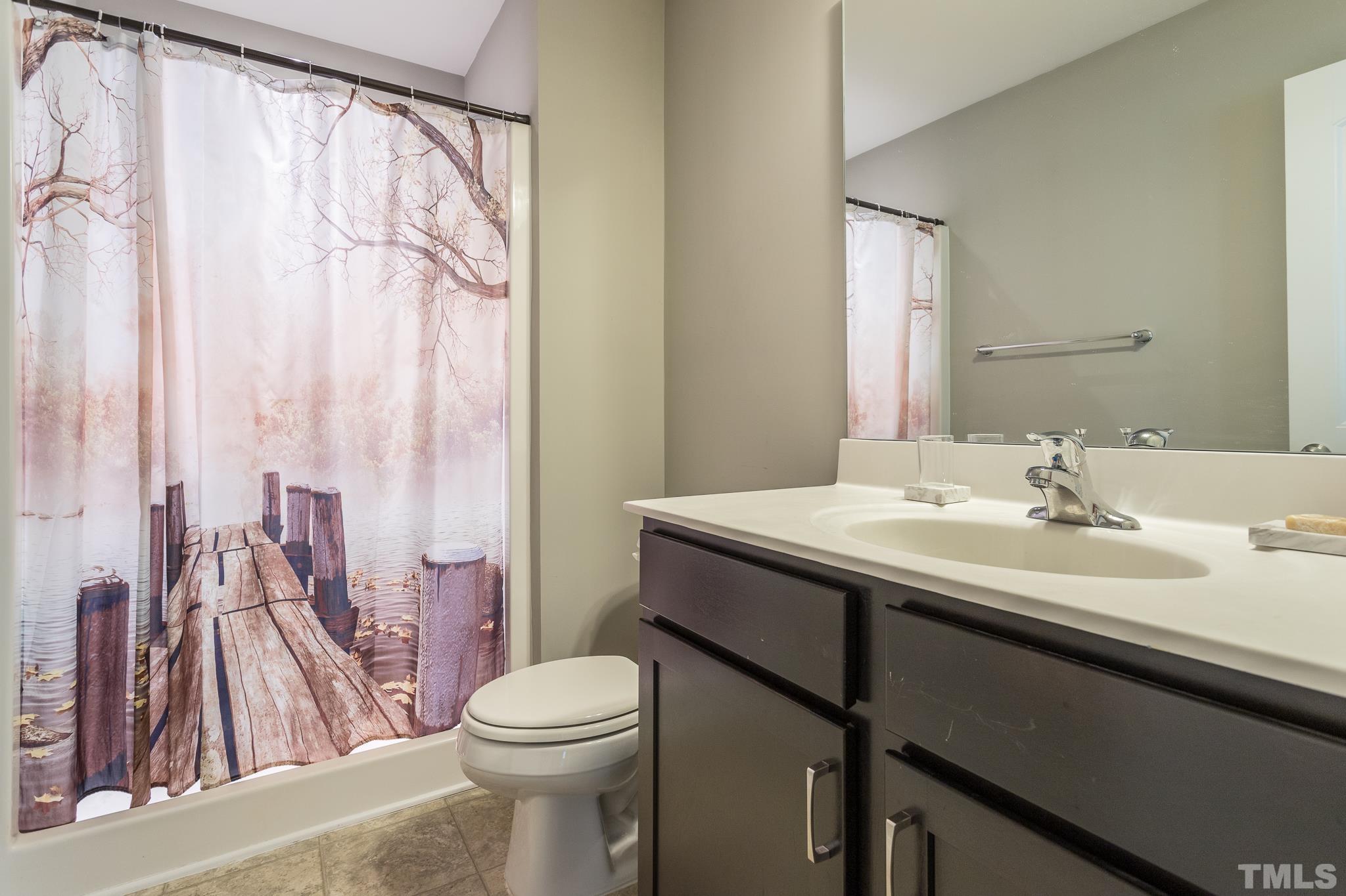 218 Irving Way Durham, NC 27703 - Photo 19 of 41 a bathroom with a sink a toilet and a mirror