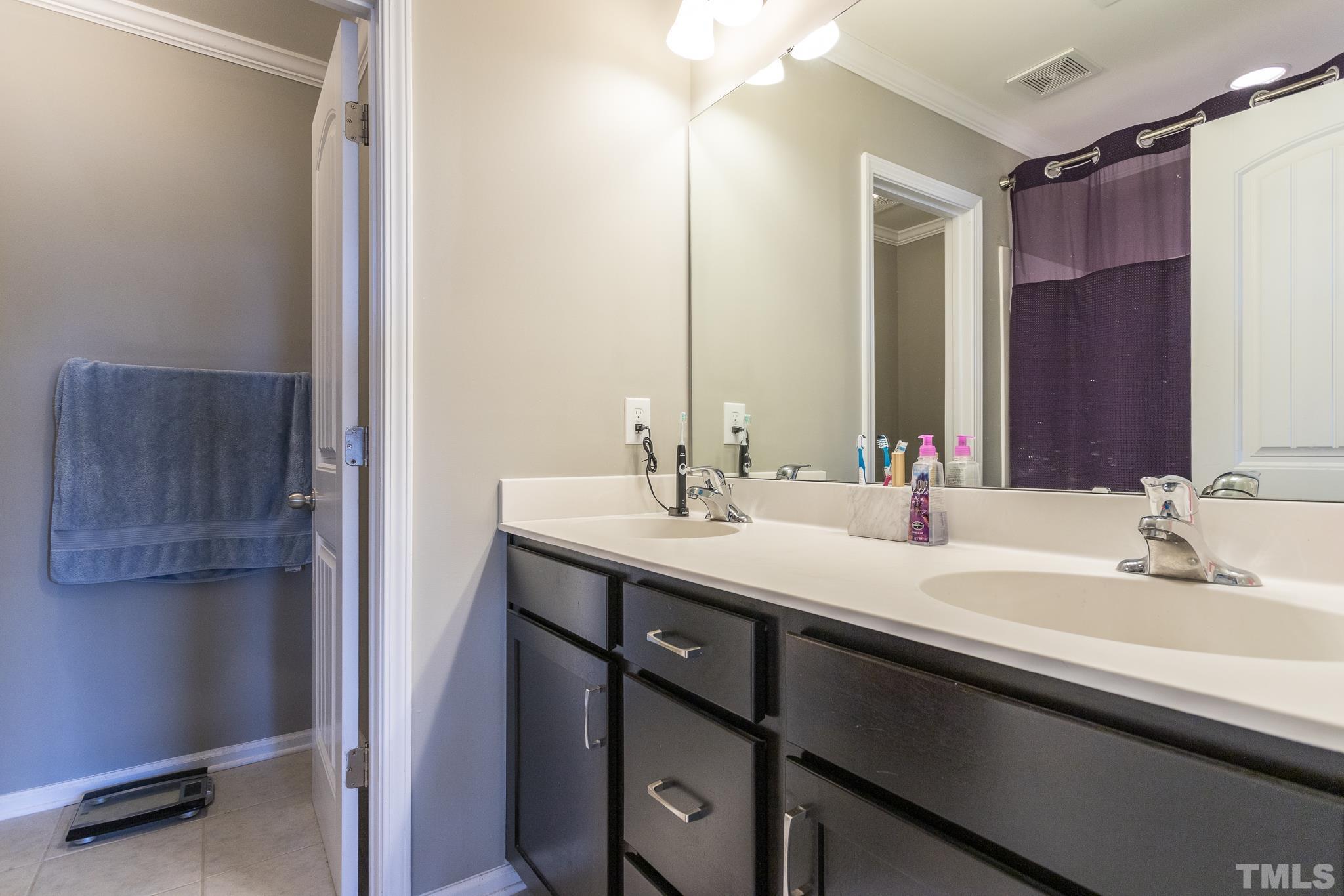 218 Irving Way Durham, NC 27703 - Photo 26 of 41 a bathroom with a double vanity sink and a mirror