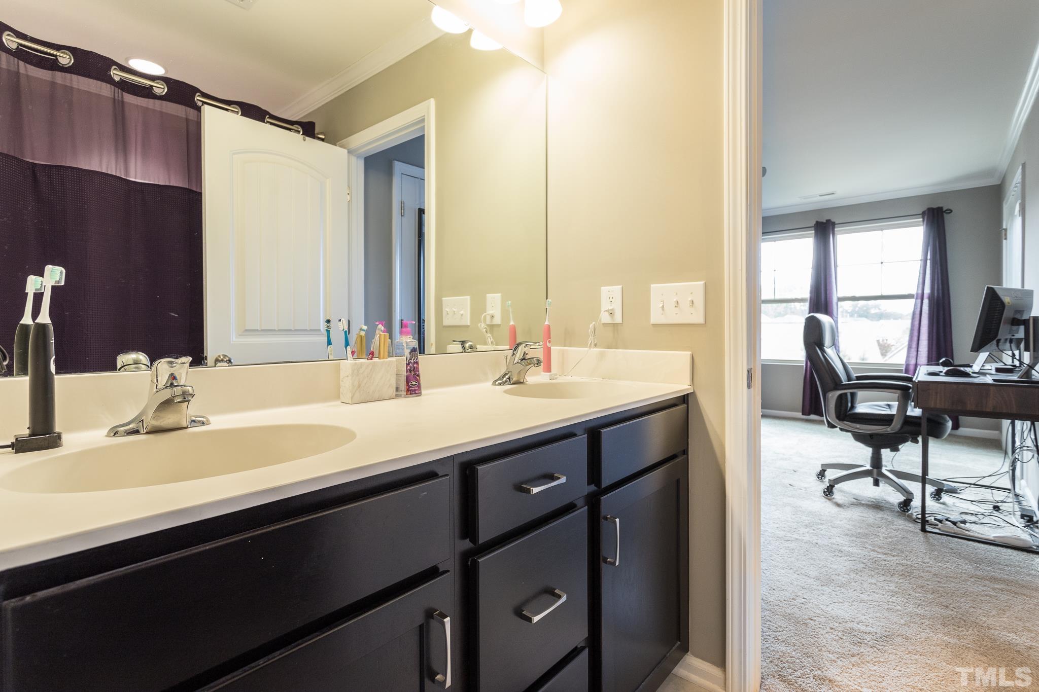 218 Irving Way Durham, NC 27703 - Photo 27 of 41 a bathroom with a sink double vanity and a mirror