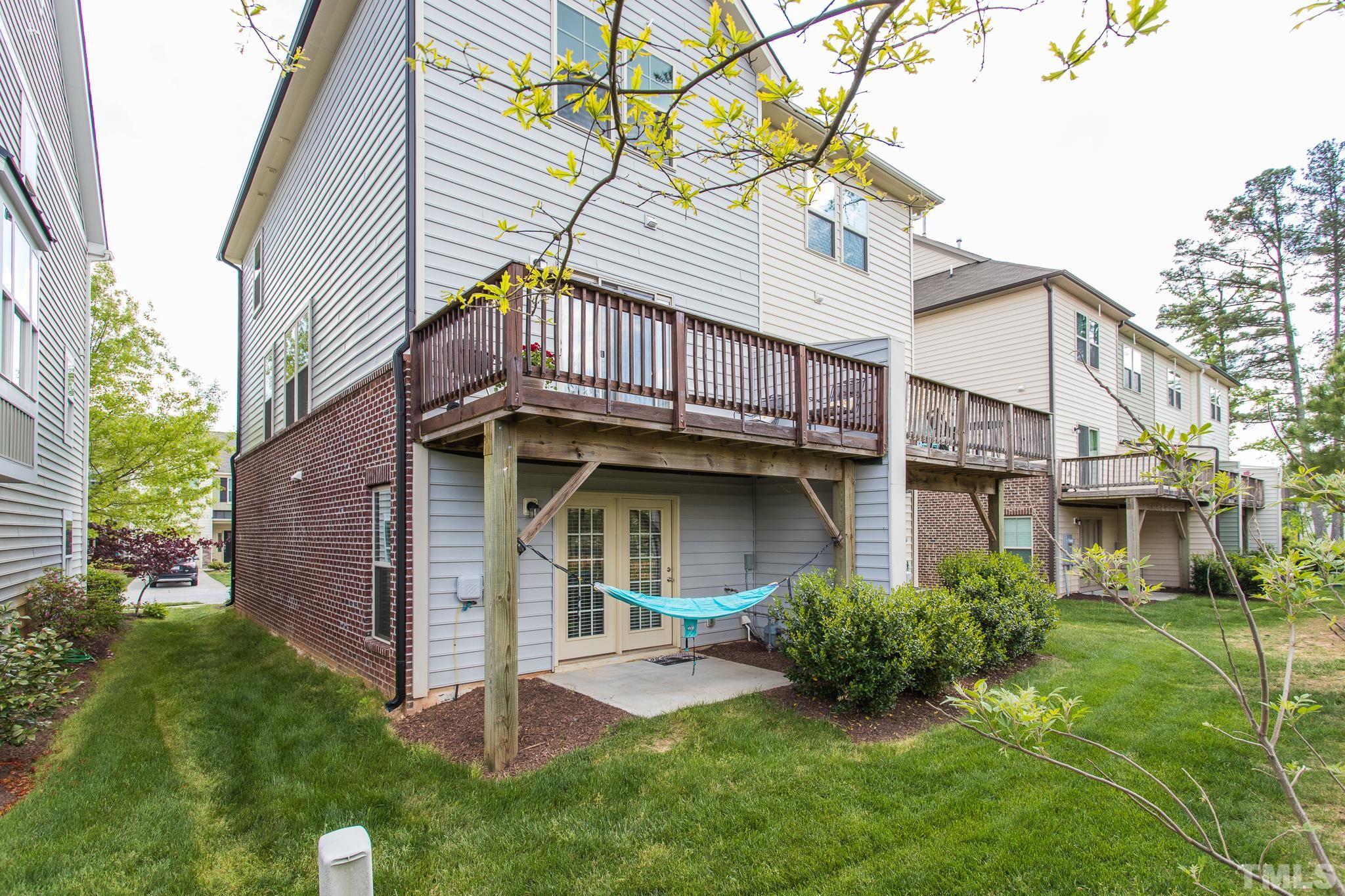 218 Irving Way Durham, NC 27703 - Photo 32 of 41 a view of a house with brick walls and a yard with plants