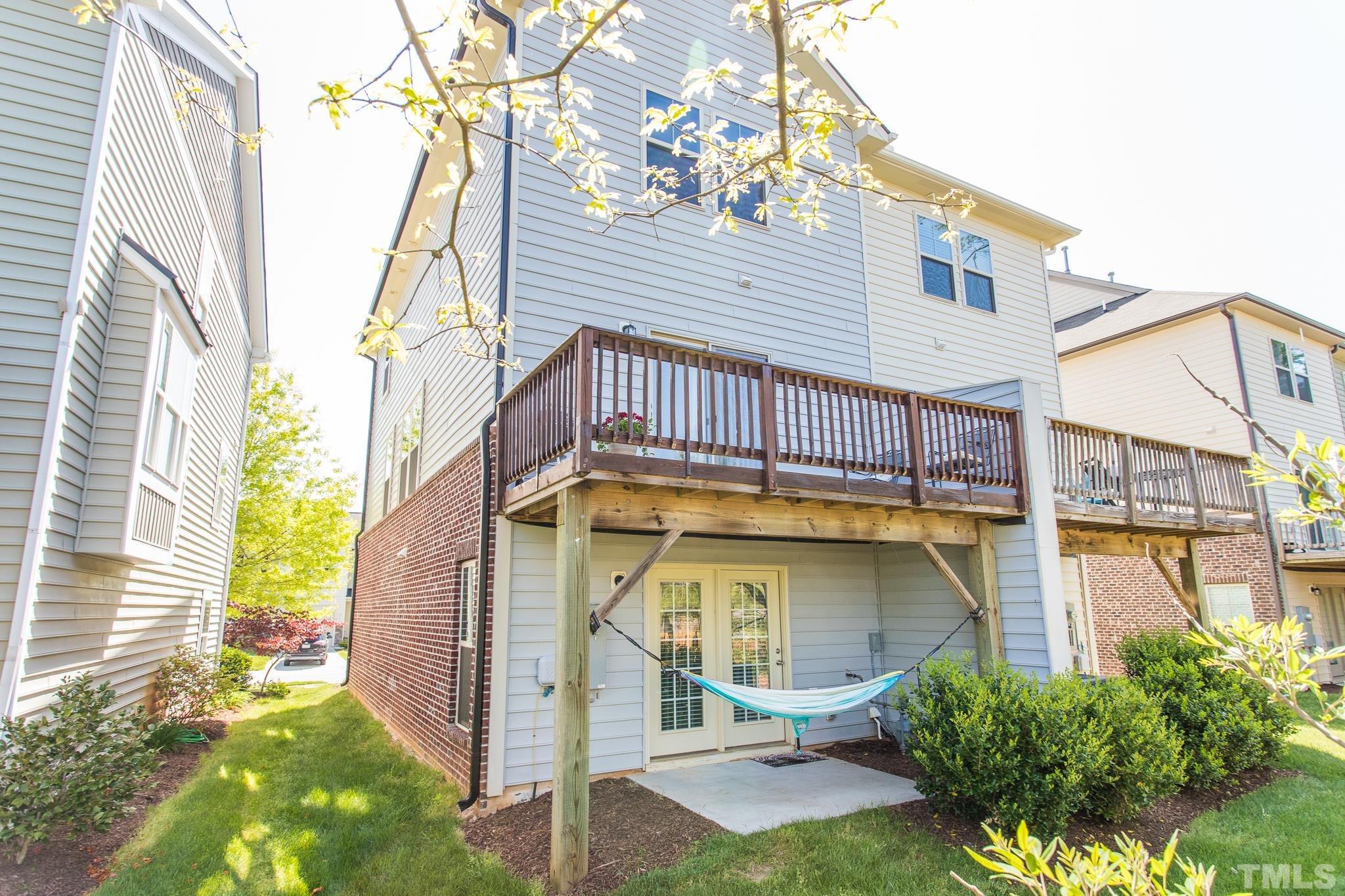 218 Irving Way Durham, NC 27703 - Photo 33 of 41 a view of a house with a small yard and wooden floor