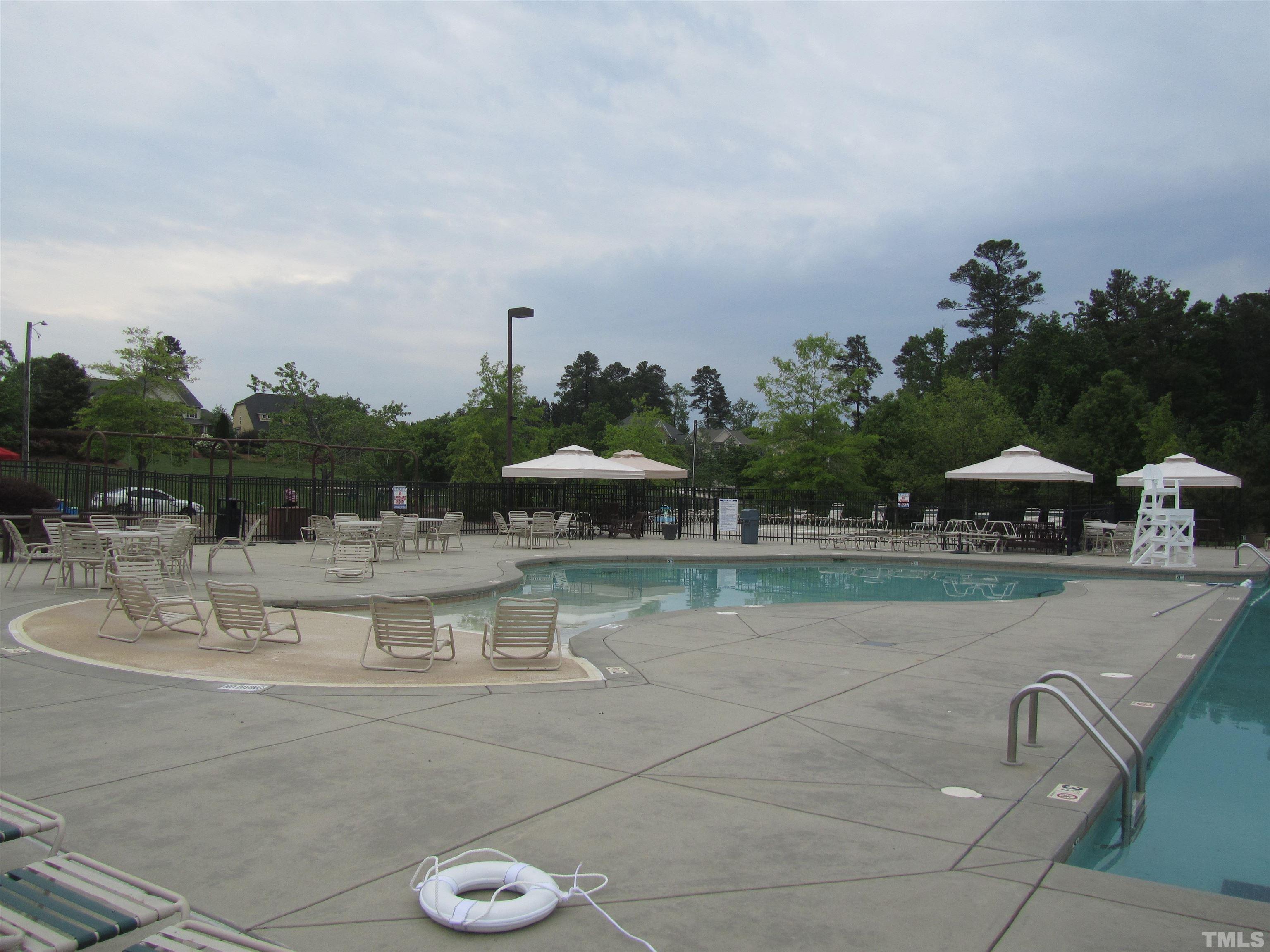 218 Irving Way Durham, NC 27703 - Photo 40 of 41 a view of swimming pool with outdoor seating and lake in the back
