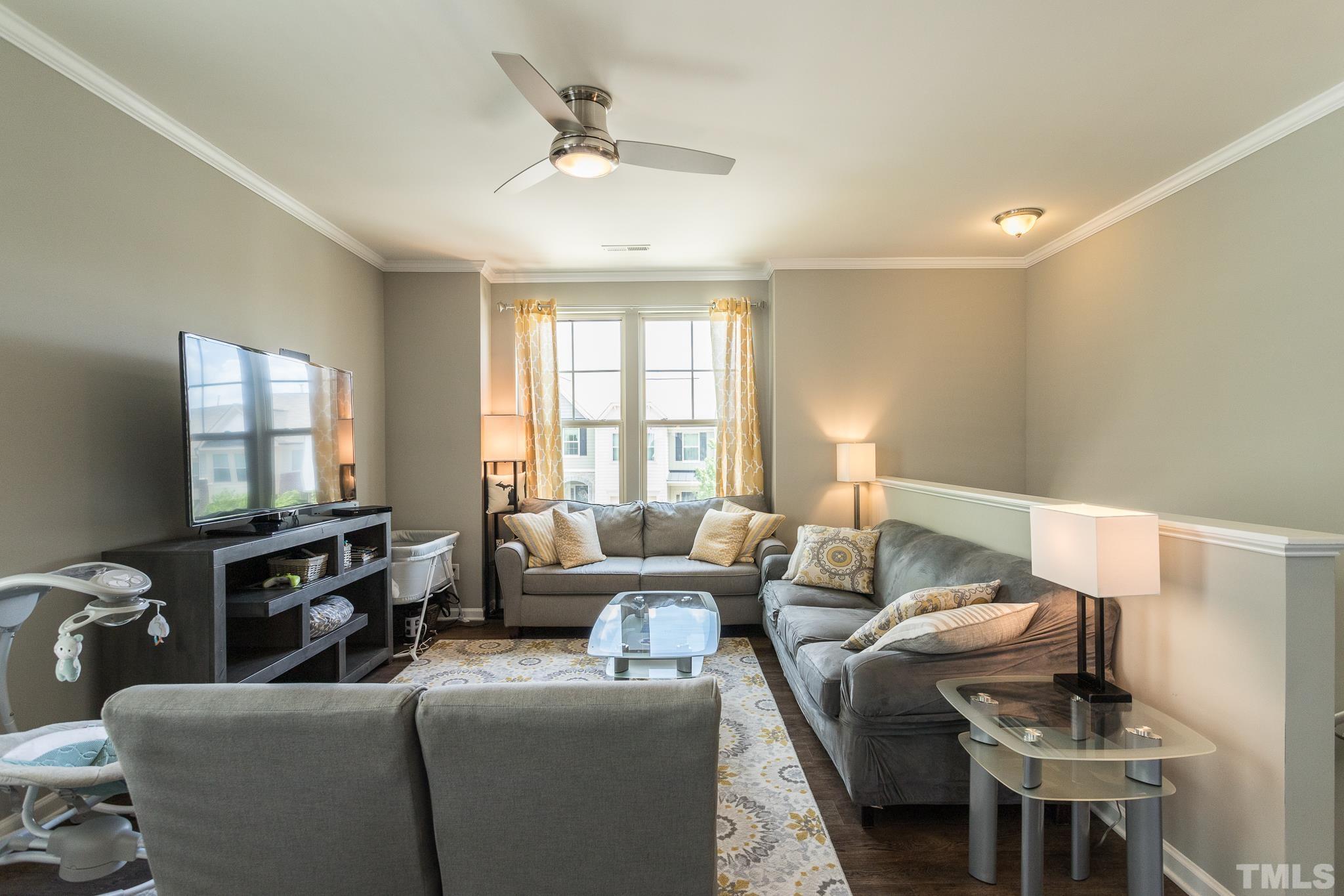218 Irving Way Durham, NC 27703 - Photo 8 of 41 a living room with furniture and a flat screen tv