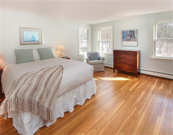 8 Meadowbrook Road Lincoln, MA 01773 - Photo 18 of 26 a bedroom with a bed and wooden floor