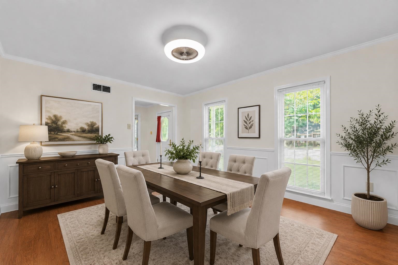 2218 Riverdale Road Germantown, TN 38138 - Photo 6 of 40 Beautiful formal dining room featuring classic wainscoting, abundant natural light, and ample space for hosting family dinners and holiday gatherings. Virtually staged to showcase the room's versatility, warmth, and timeless charm.