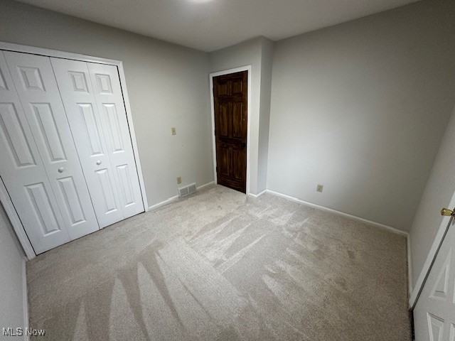 586 Ingalls Road Akron, OH 44312 - Photo 12 of 21 Unfurnished bedroom featuring light colored carpet and a closet