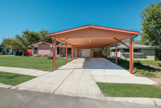 a view of a house with backyard and sitting area