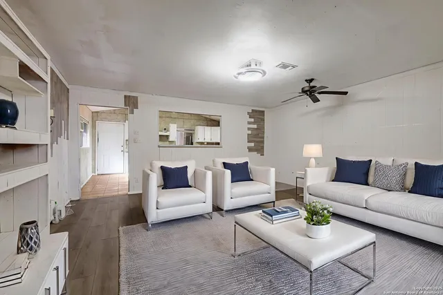 a living room with furniture and a lamp