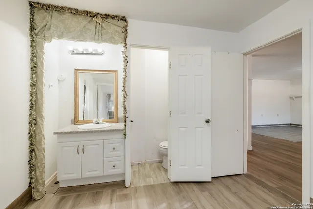 a view of a cabinet with wooden floor and cabinet