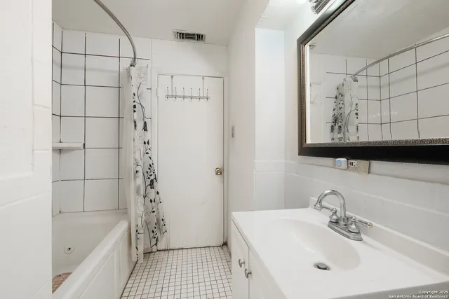 a bathroom with a bathtub a sink and a shower