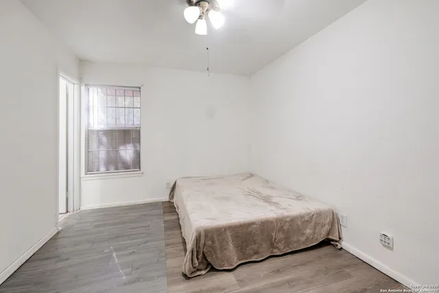 a bedroom with a bed and a window