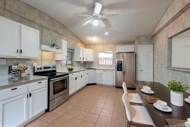 a kitchen with a sink cabinets and window