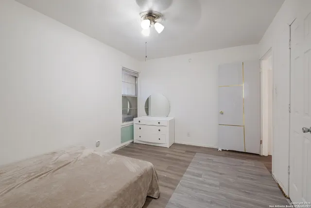 a room with a bed and cabinets