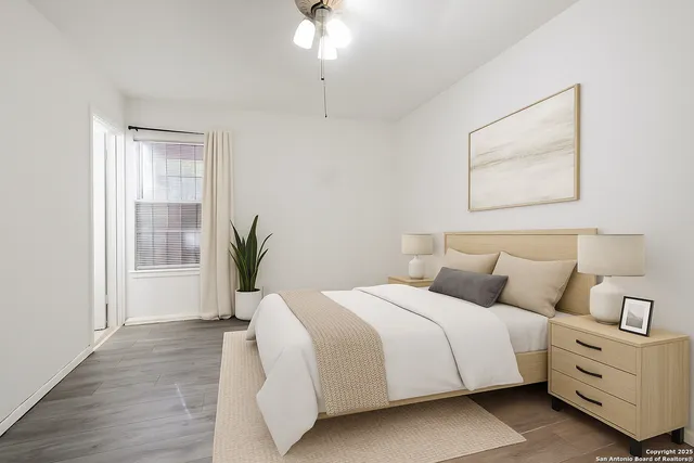 a bedroom with a large bed and a window