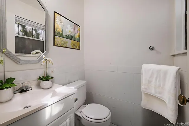 a bathroom with a toilet sink and mirror