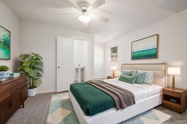 a bedroom with a large bed and a chandelier