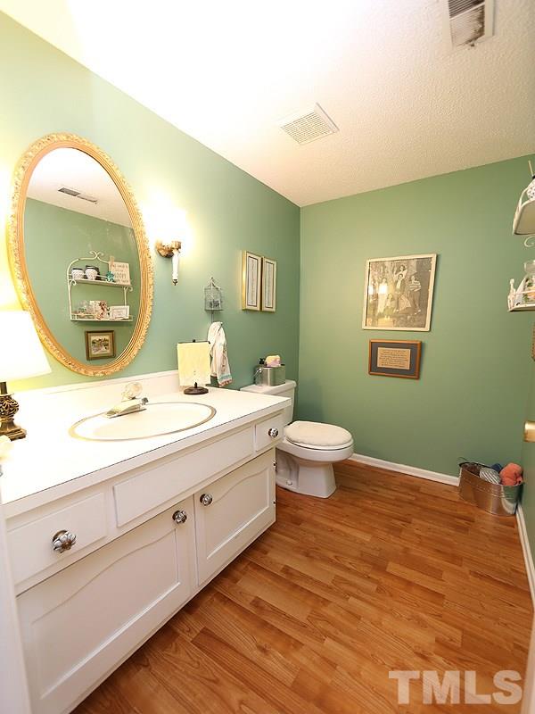 3163 Morningside Drive Raleigh, NC 27607 - Photo 11 of 18 a bathroom with a toilet sink and mirror