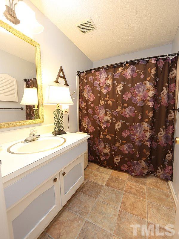 3163 Morningside Drive Raleigh, NC 27607 - Photo 13 of 18 a bathroom with a sink and a mirror