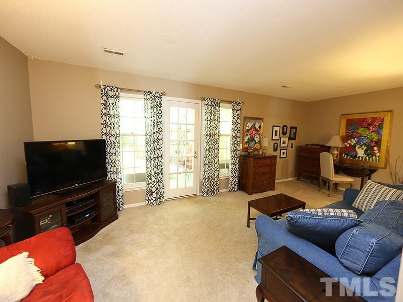 3163 Morningside Drive Raleigh, NC 27607 - Photo 4 of 18 a living room with furniture and a flat screen tv