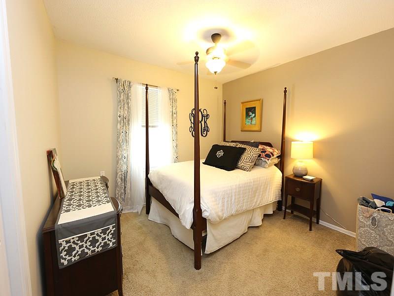 3163 Morningside Drive Raleigh, NC 27607 - Photo 10 of 18 a bed room with a bed and a chair