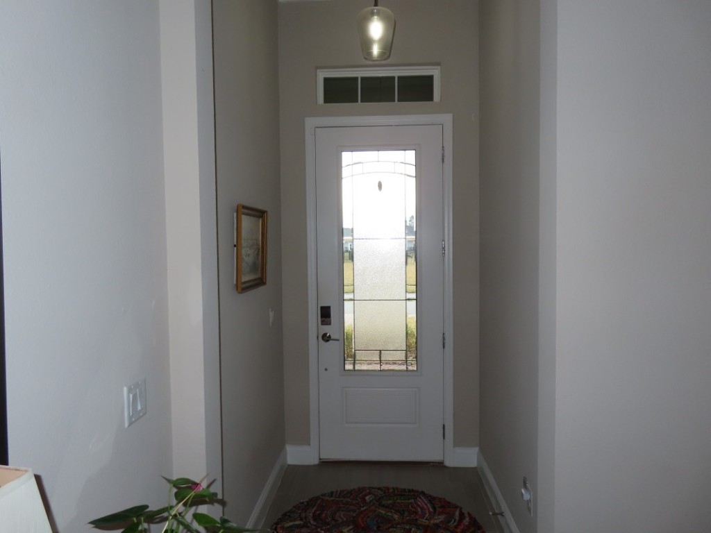75136 White Rabbit Avenue Yulee, FL 32097 - Photo 11 of 23 a view of a hallway with wooden door