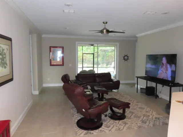 a living room with furniture a piano and a window