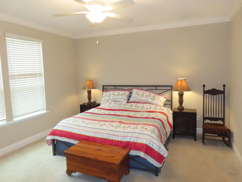 75136 White Rabbit Avenue Yulee, FL 32097 - Photo 17 of 23 a bedroom with a bed and a chandelier