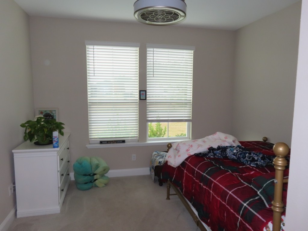 75136 White Rabbit Avenue Yulee, FL 32097 - Photo 19 of 23 a bed sitting in a bedroom next to a window