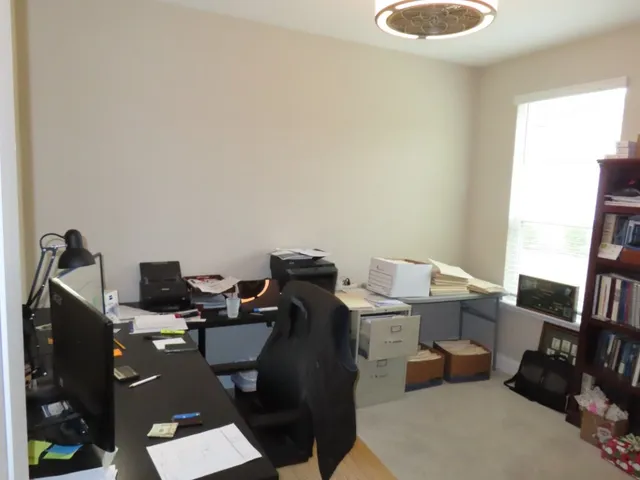 a workspace with furniture and a window