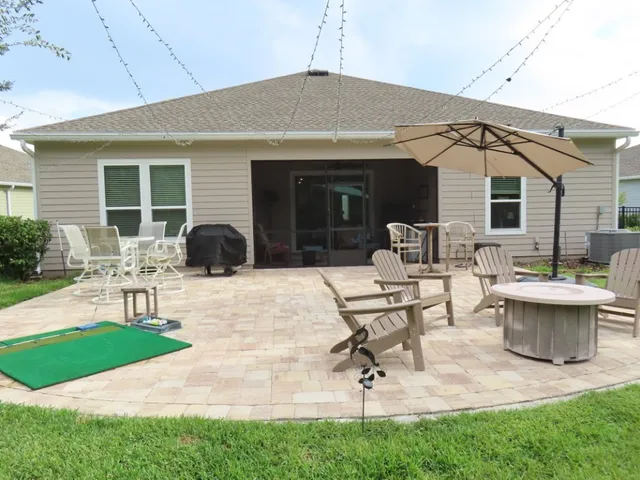 a view of a patio with couches table and chairs with garden