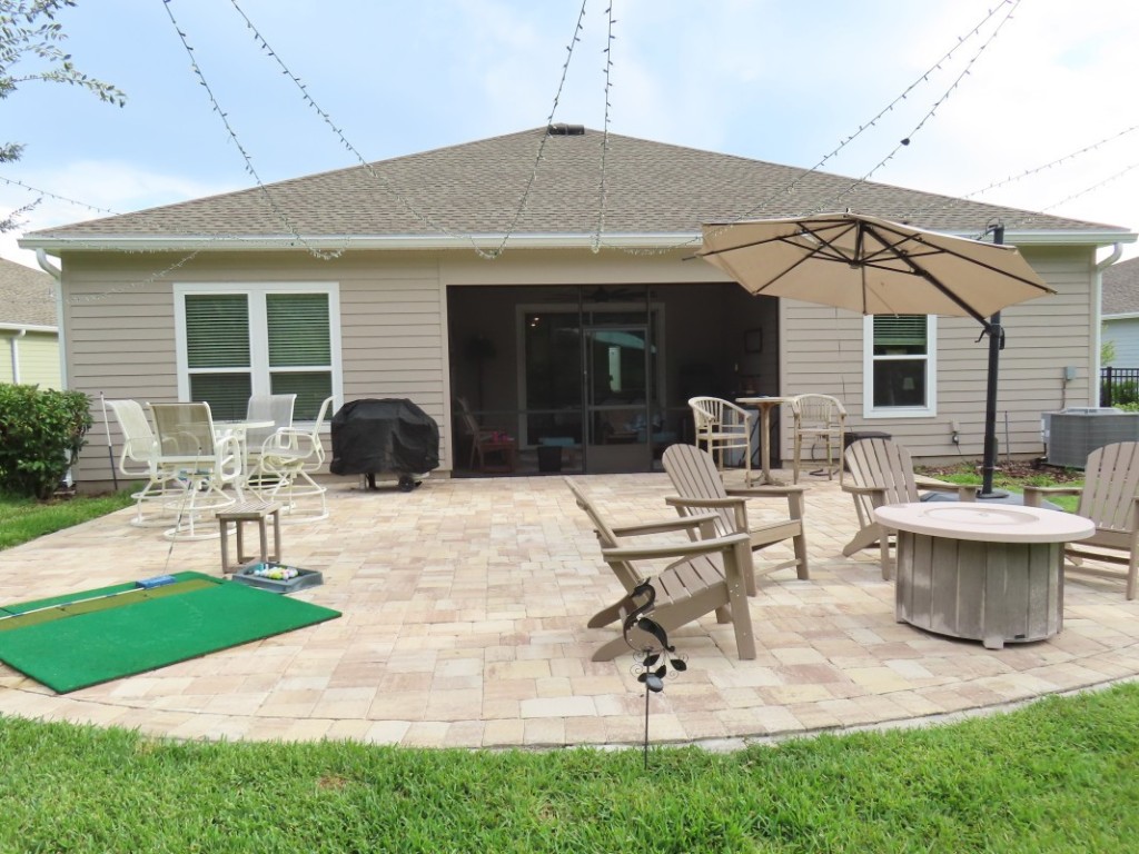 75136 White Rabbit Avenue Yulee, FL 32097 - Photo 4 of 23 a view of a patio with couches table and chairs with garden
