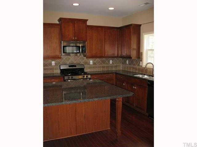 2105 Lower Lake Road Wake Forest, NC 27587 - Photo 6 of 12 Gorgeous kitchen!! Tons of counter space & cabinet space! And check out the huge island with table leg! Beautiful & functional! Kitchen