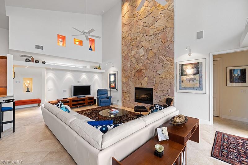 433 Crestwood Road Naples, FL 34113 - Photo 12 of 50 a living room with furniture and a fireplace