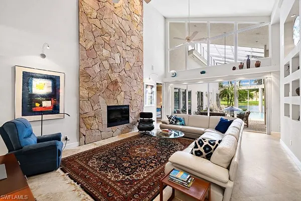 a living room with furniture a rug and a fireplace