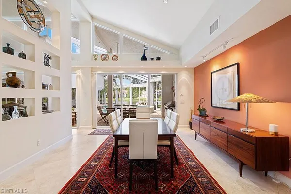 a dining room with wooden floor and furniture