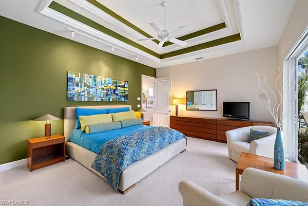 a bedroom with a bed couch and a window