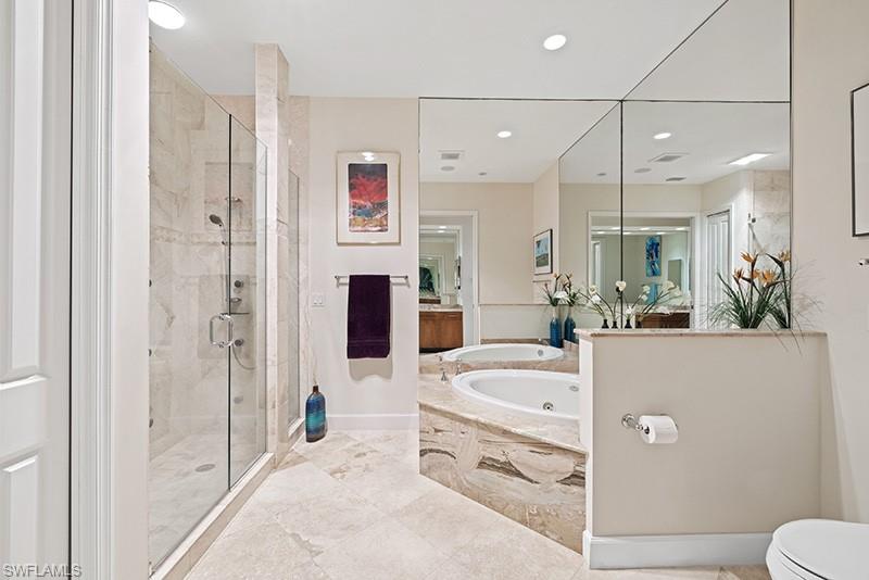 433 Crestwood Road Naples, FL 34113 - Photo 20 of 50 a bathroom with a tub a sink a mirror and shower
