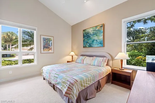 a bedroom with a large bed and a window