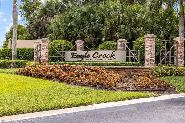 a view of a park with iron fence