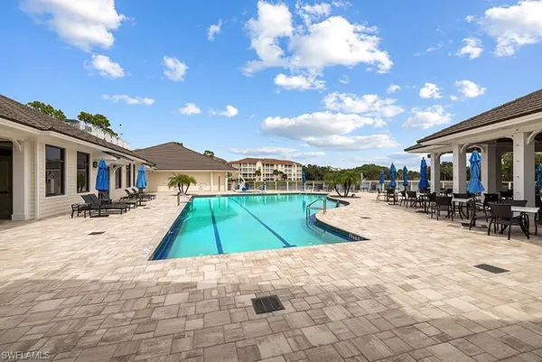 a view of a house with swimming pool and sitting area