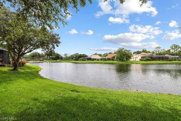a view of a lake with houses in the back