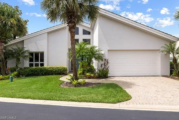 a front view of house with a garden