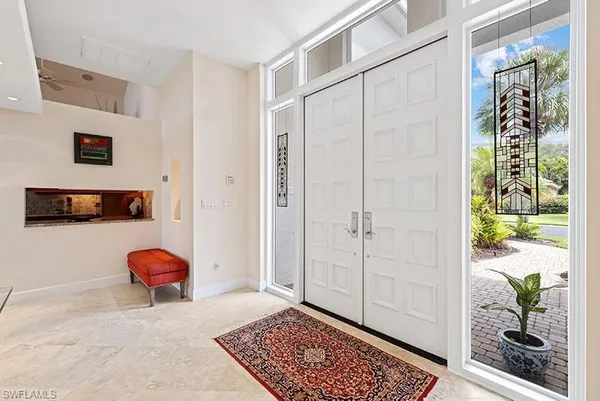 a living room with a rug and a window
