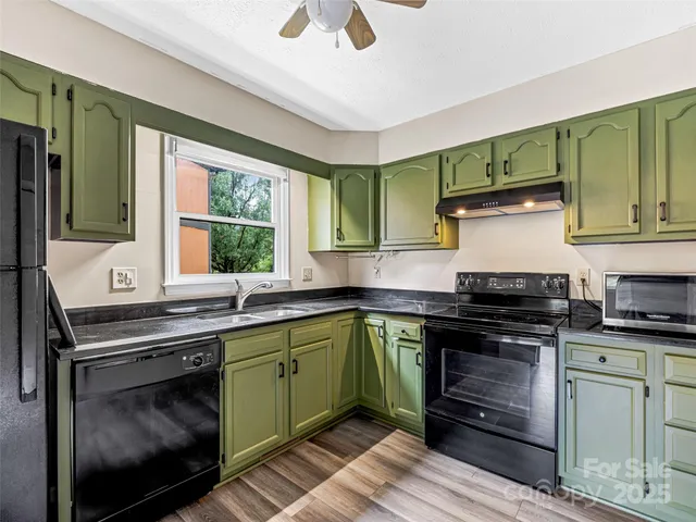 a kitchen with cabinets and outdoor space