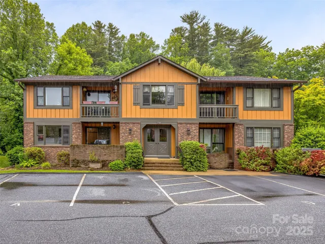 a front view of a house with a yard and a garage