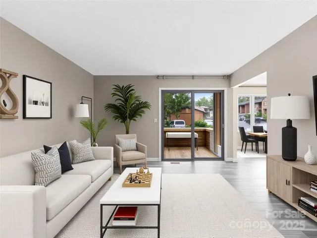 a dining room with furniture wooden floor and a chandelier