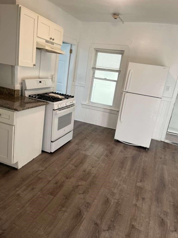 1709 Pleasant Street, Unit 2W Fall River, MA 02723 - Photo 2 of 8 a kitchen with granite countertop a stove a sink and a microwave