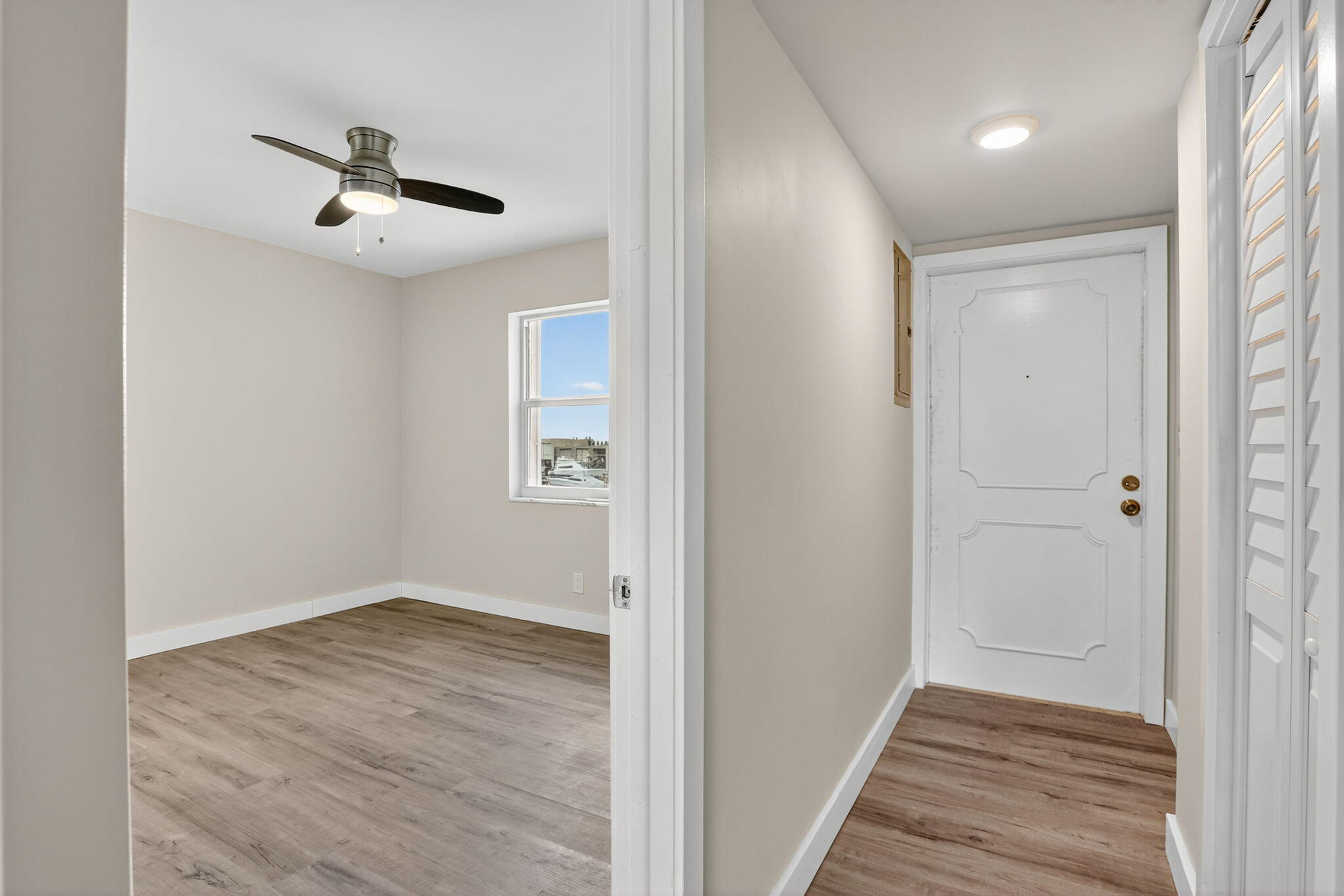 3201 Northeast 14th Street Causeway, Unit 501 Pompano Beach, FL 33062 - Photo 22 of 32 a view of a hallway with wooden floor and staircase